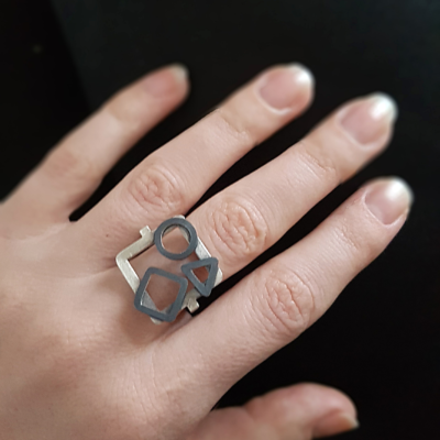 Handmade Geometric Statement Ring in Oxidised Sterling Silver is worn on the middle finger.