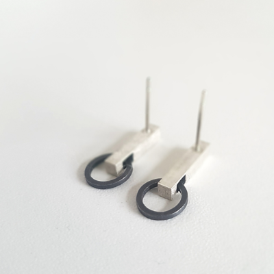 Handmade Minimalist Patina Silver Stud Earrings (back view) is shown on the white surface.