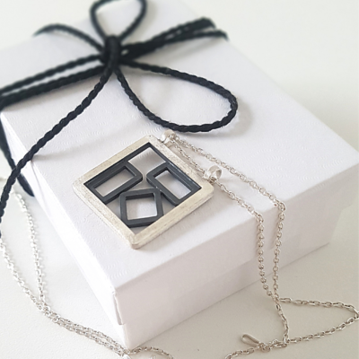 Handmade Patina Silver Pendant Necklace is placed on the white paper gift box tied with black cotton string.