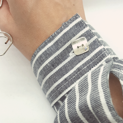 Artisan Custom Minimalist Silver CZ Apparel Button is shown on the striped shirt.