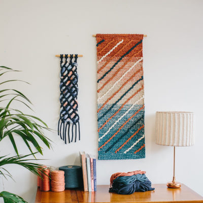 Cassandra Sabo’s ‘Shoreline’ handwoven textile wall-hanging from her West Coast Collection hung on the wall beside another Macraweave wall-hanging.