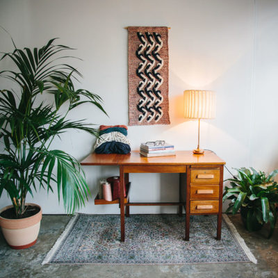 Cassandra Sabo’s ‘Elude’ handwoven textile wall-hanging from her West Coast Collection hung on the wall above a desk