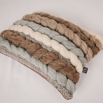 Cassandra Sabo’s handwoven wool, rectangular 'Double Tendril' cushion from her Forest Collection photographed on an angle