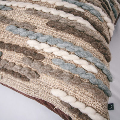 Texture detail of the handwoven 'Caterpillar' cushion featuring Merino wool by Cassandra Sabo