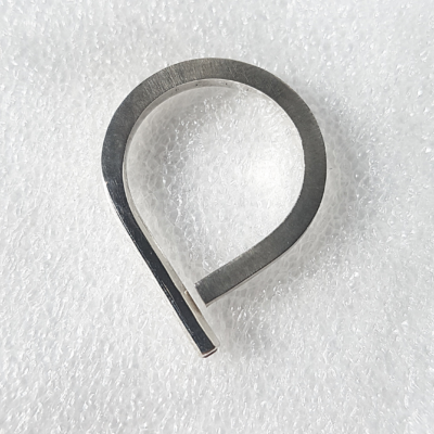 Sterling silver Statement open ring with garnet is placed on the white surface.
