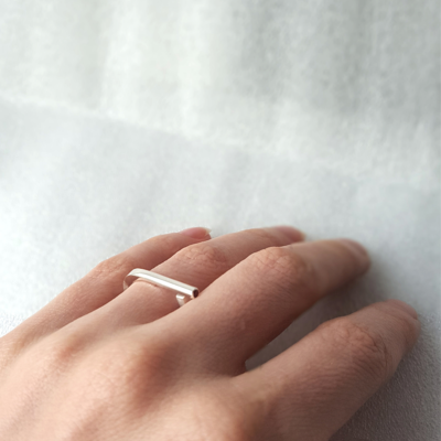 Statement sterling silver ring is shown on the 4th finger of the palm.