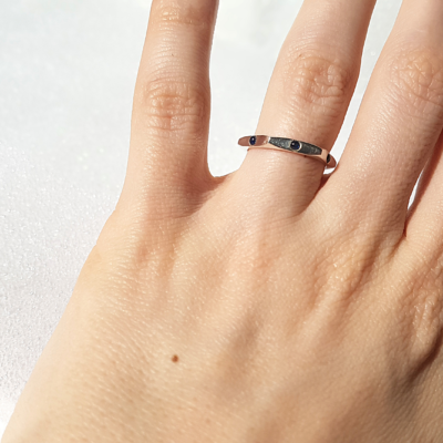 Contemporary sterling silver ring is shown on the 4th finger of the palm.