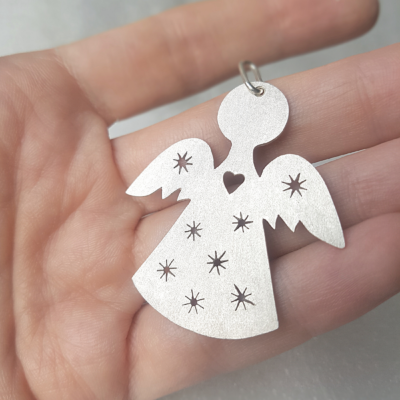 Silver Angel-Shaped Hanging Keepsake on the palm.