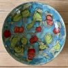 large cherry bowl on teal
